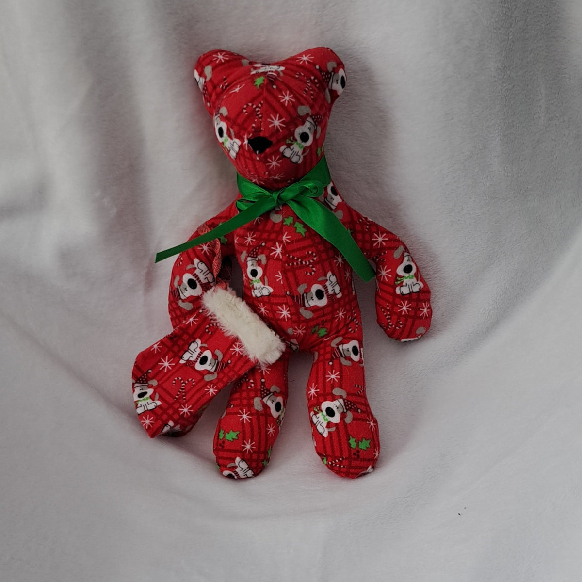 14"tall x 10"wide bear, flannel 
Snoopy Dog Christmas pattern, embroidered nose eyes are part of pattern, He comes with his own little stocking made with same flannel pattern & top with white fur.
