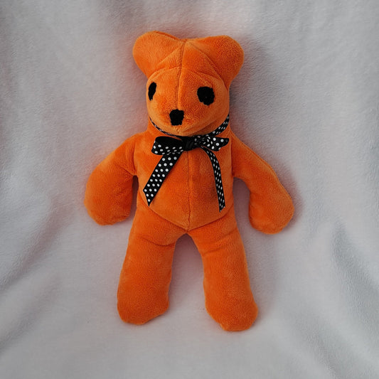 14"tall x 10"wide stuffed orange minky bear, embroidered eyes & nose, black poked bow with white dots, safe for all ages

